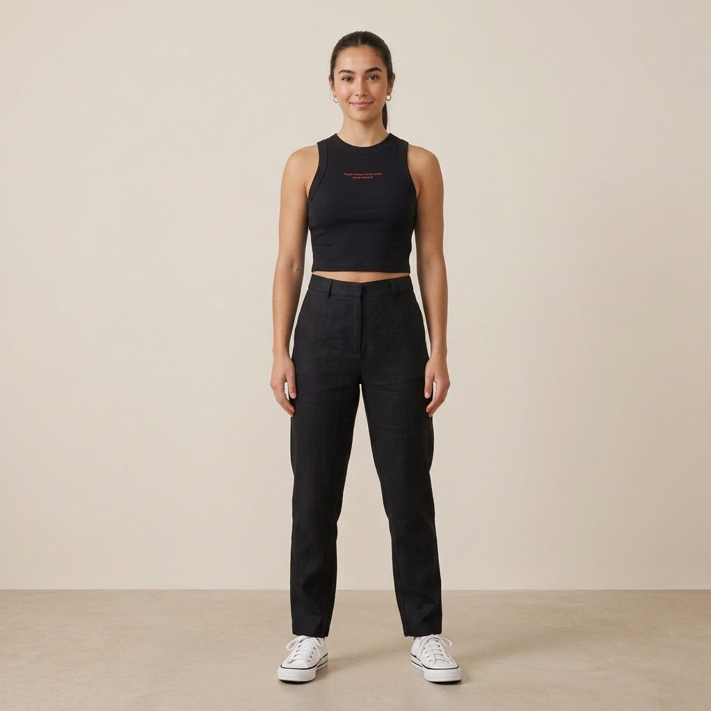 Model wearing a black cropped tank top