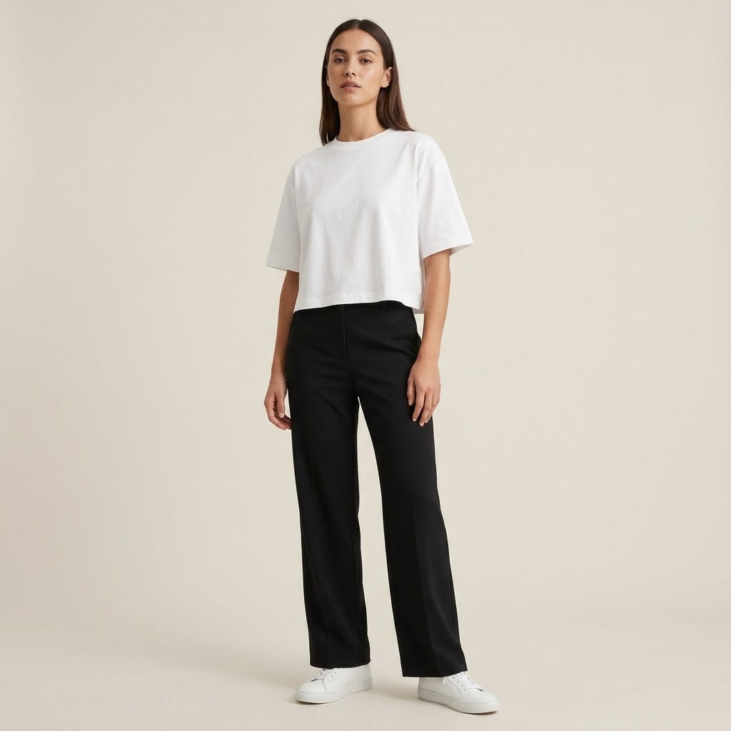 Model wearing a white boxy cropped tee